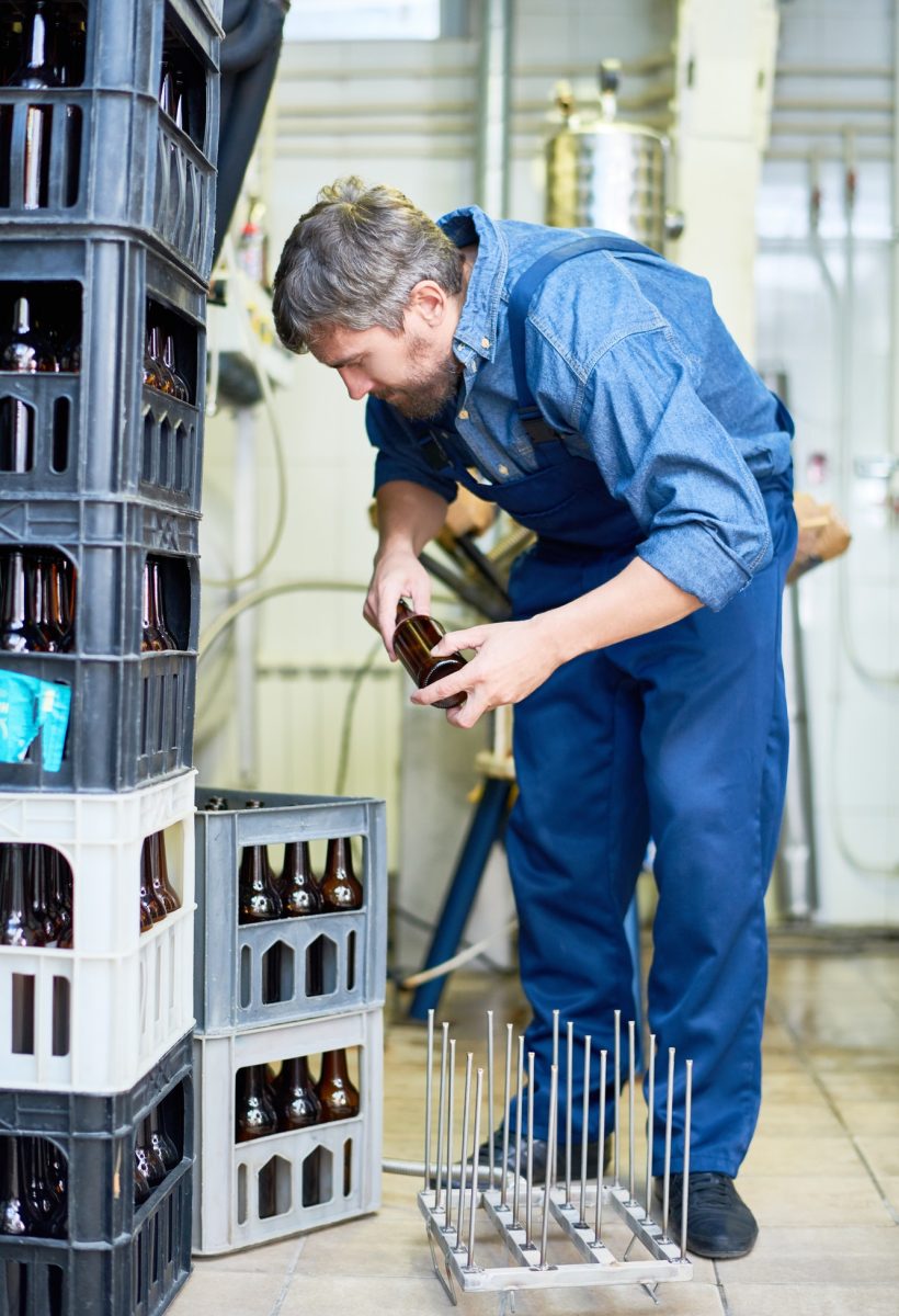 modern-brewery-worker-preparing-beer-bottles-for-loading.jpg
